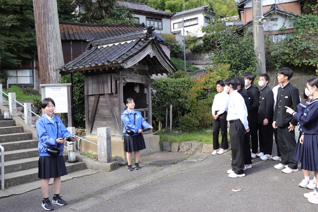 青林寺の前で案内をする高校生