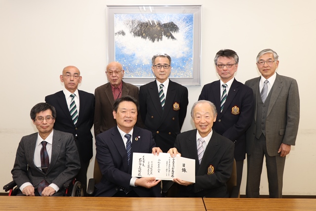 茶谷市長に目録を手渡す水野会長