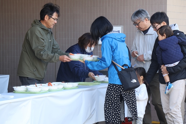 海鮮鍋をもらうお客さんたち